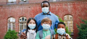 teacher with three students in masks