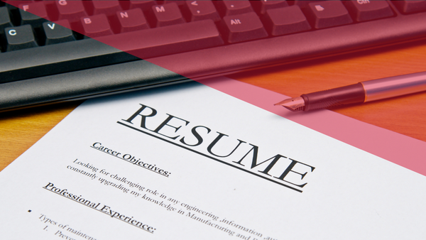 resume, keyboard, and pen on a desk