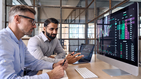 Two men working on a computer.