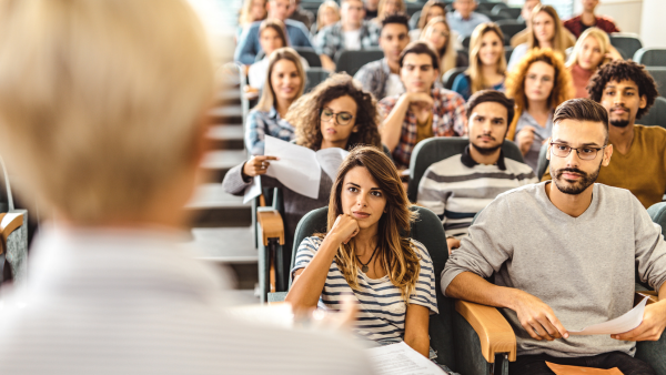 A classroom full of college students listening to a lecture. 