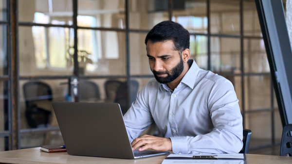 A man conducting research on his computer. 