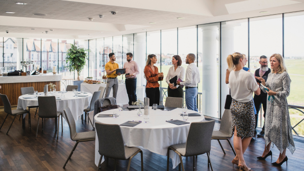 A group of professionals meeting at an event. 