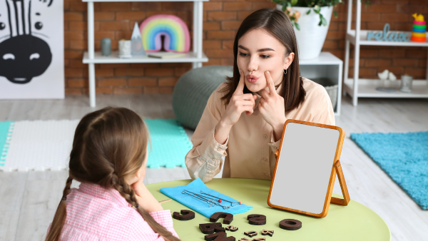 A woman teaching a child at a table. 