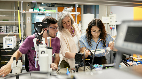 Three engineers working in a lab. 